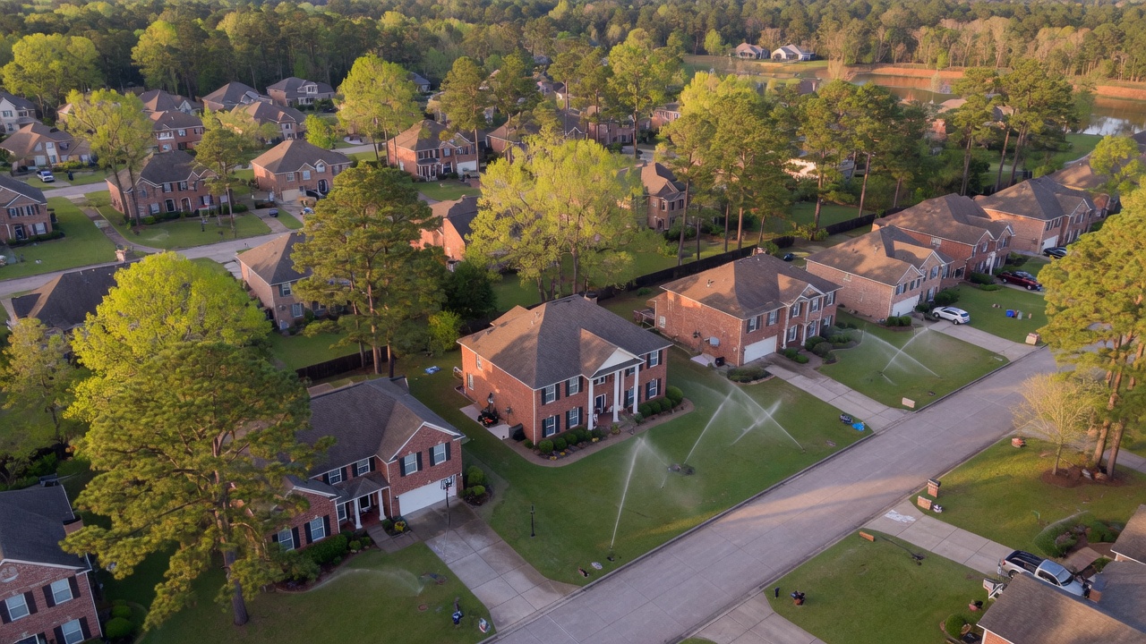 Spring Texas neighborhood lawns with sprinklers running